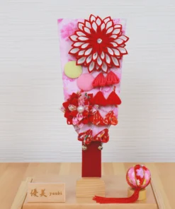 Hagoita paddle with red floral decorations. Wholesale by Fujiki Crafts.