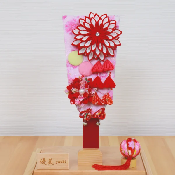 Hagoita paddle with red floral decorations. Wholesale by Fujiki Crafts.