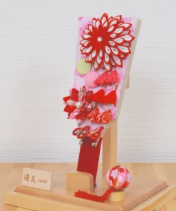 Hagoita paddle with red floral decorations. Wholesale by Fujiki Crafts.