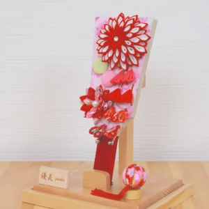 Hagoita paddle with red floral decorations. Wholesale by Fujiki Crafts.