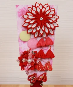 Hagoita paddle with red floral decorations. Wholesale by Fujiki Crafts.