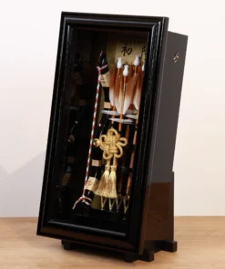 Traditional Japanese Hamaya arrow display with golden accents in black case, for cultural decor and protective gift sets. Wholesale by Fujiki Crafts.