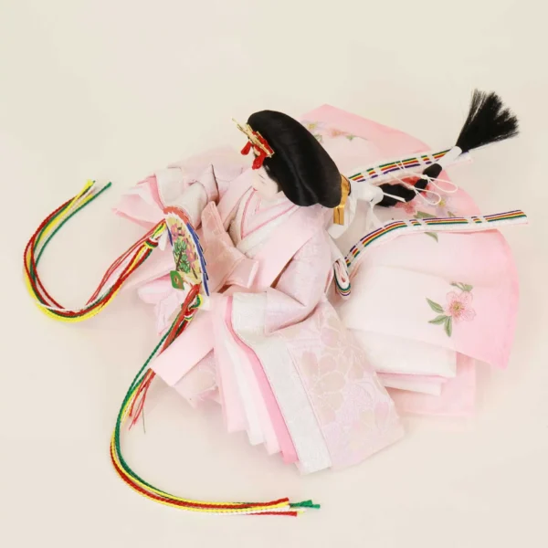 Empress Hina doll in layered pink kimono with floral fan. Wholesale by Fujiki crafts.