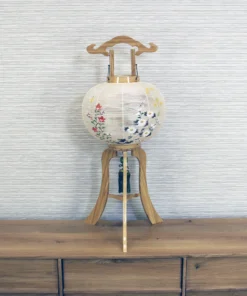 Handcrafted Japanese Bonbori lantern with washi paper shade, featuring hand-painted red spider lilies, wild daisies, and yellow rapeseed flowers on a natural wood stand. Wholesale by Fujiki Crafts.