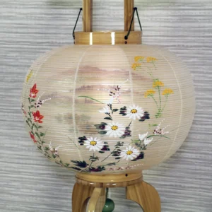 Handcrafted Japanese Bonbori lantern with washi paper shade, featuring hand-painted red spider lilies, wild daisies, and yellow rapeseed flowers on a natural wood stand. Wholesale by Fujiki Crafts.