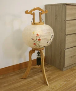 Handcrafted Japanese Bonbori lantern with washi paper shade, featuring hand-painted red spider lilies, wild daisies, and yellow rapeseed flowers on a natural wood stand. Wholesale by Fujiki Crafts.