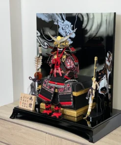 Handcrafted Japanese Samurai armor set in red and black, displayed with dragon and tiger backdrop. Wholesale by Fujiki Crafts