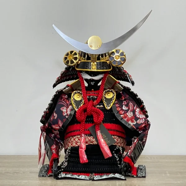 Handcrafted Japanese Samurai armor set in red and black, displayed with dragon and tiger backdrop. Wholesale by Fujiki Crafts