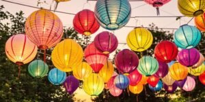 Colorful paper lanterns hanging outdoors in festive arrangement.