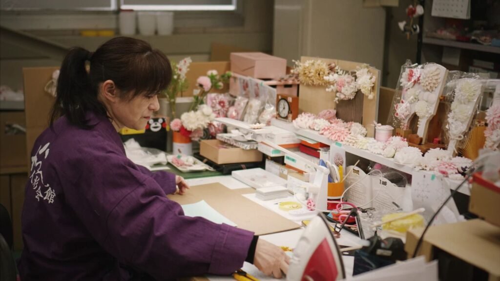 A creative workspace filled with flowers and crafting supplies.