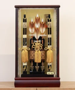 Japanese Hamaya arrows display with gold tassels, feathered shafts, and traditional Japanese accents set against a golden backdrop. Wholesale by Fujiki Crafts.