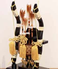 Japanese Hamaya arrows display with gold tassels, feathered shafts, and traditional Japanese accents set against a golden backdrop. Wholesale by Fujiki Crafts.