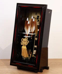 Japanese Hamaya arrows display set featuring golden arrows, black scabbard sword, and ornate gold tassel in black lacquer case. Wholesale by Fujiki Crafts.
