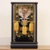 Decorative Japanese Hamaya arrow display encased in glass, featuring golden tassels, black lacquered base, and symbolic arrows with feathers, used for protection and blessings. Wholesale by Fujiki Crafts.