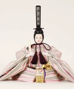Close-up of Japanese Emperor Hina Doll in striped pastel kimono with black hat and fan, seated in formal pose on white background. Wholesale by Fujiki Crafts.